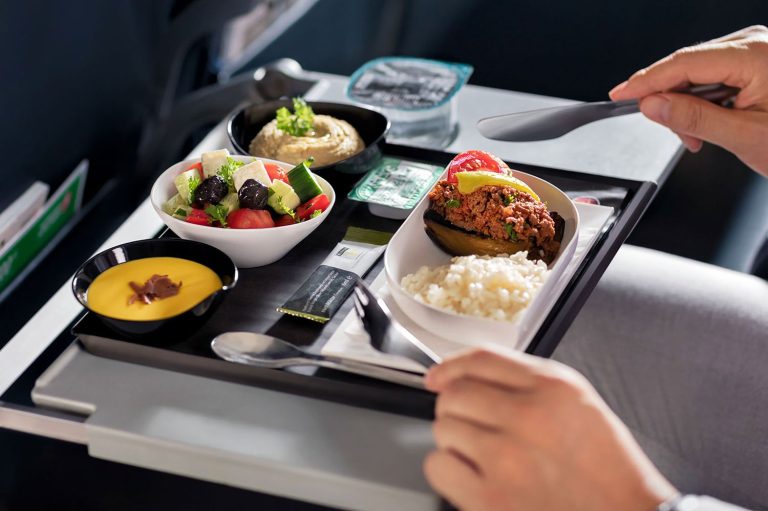 Airplane Food | Airplane meal tray on fold-out table | Evolve Tours