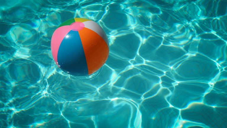 Summer | Beach ball floating in pool | Evolve Tours