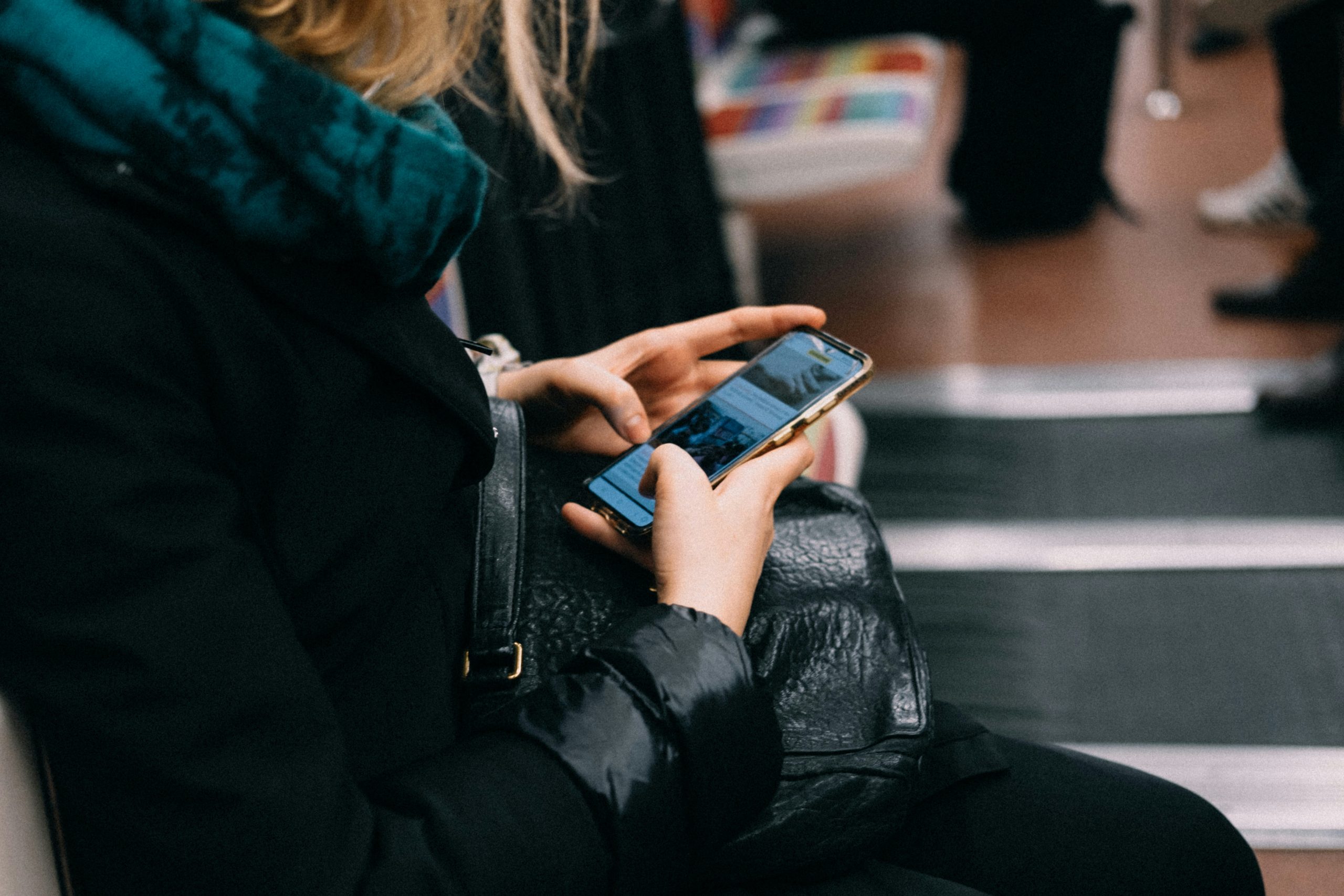 Travel Apps for Teachers | Woman checking phone while traveling | Evolve Tours