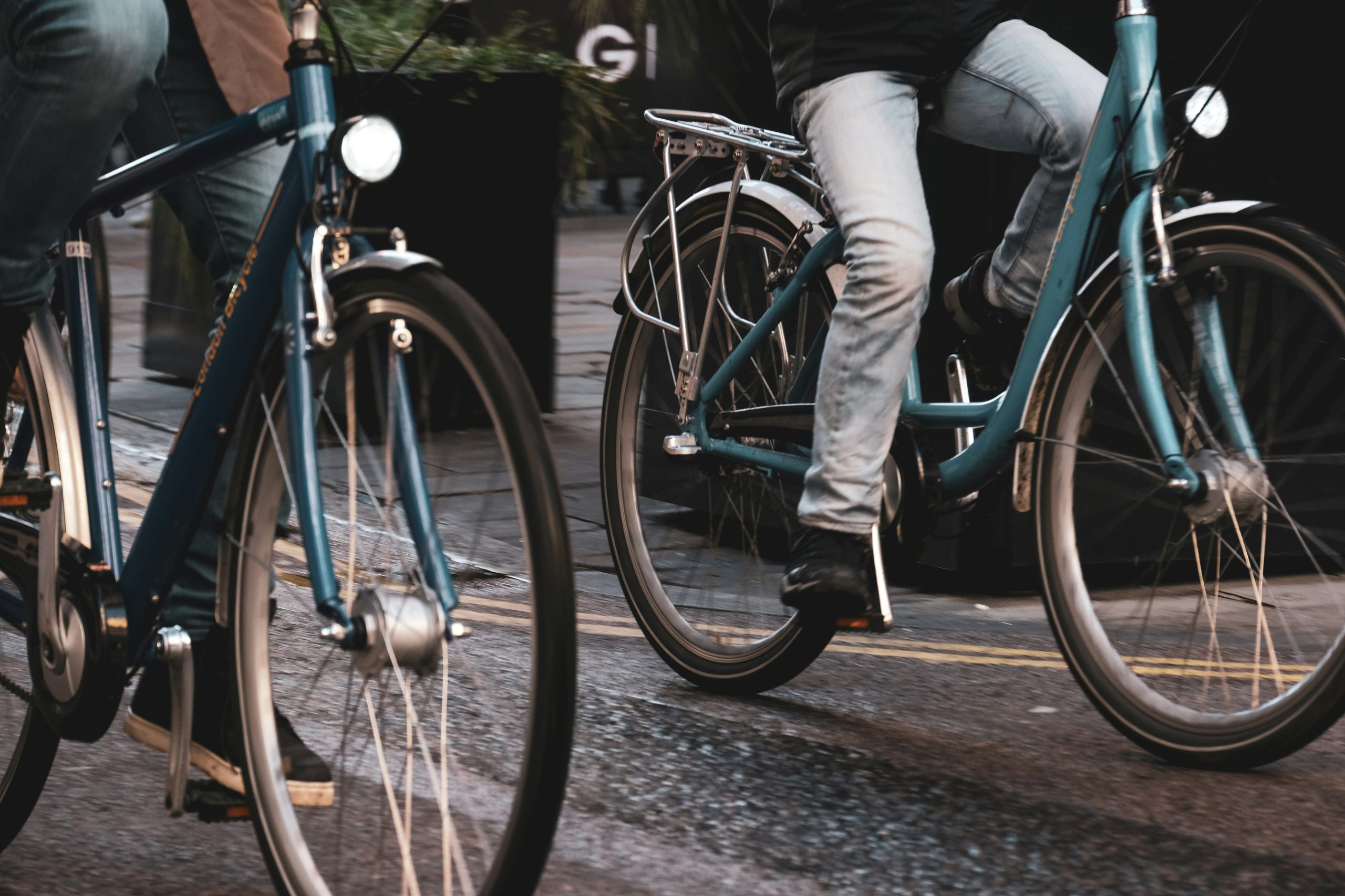 Green Transportation Revolution | Closeup of two people biking on road | Evolve Tours