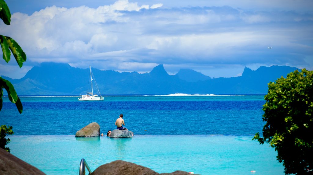 Tahiti Student Trip | Person on rock in water | Evolve Tours