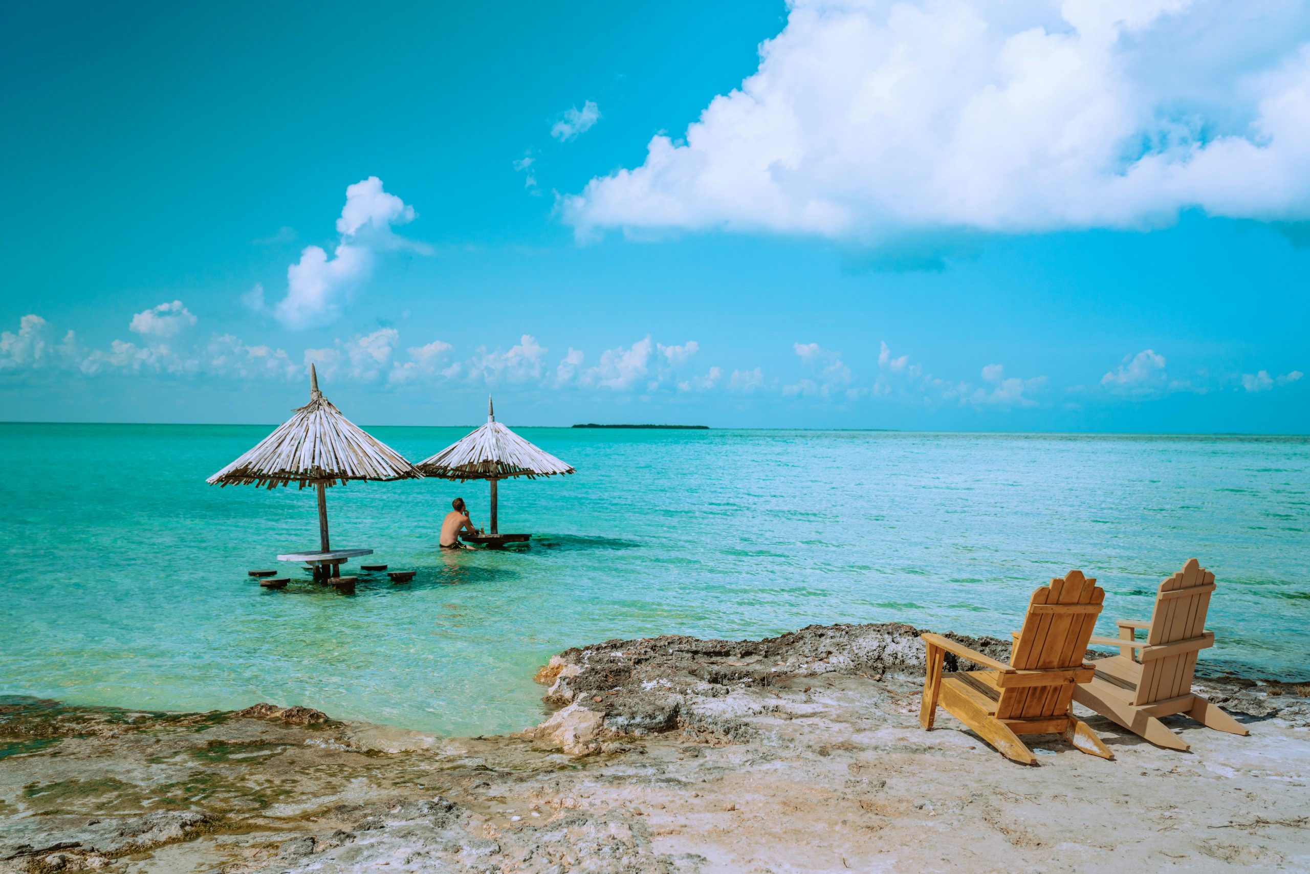 Belize School Trip | Umbrella huts on secluded beach | Evolve Tours