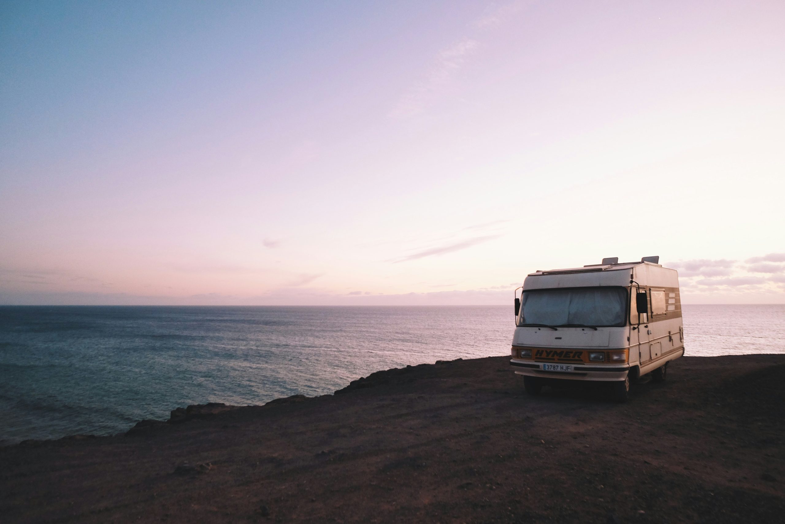 RV Parks in Western Canada | RV on cliff overlooking sunset | Evolve Tours