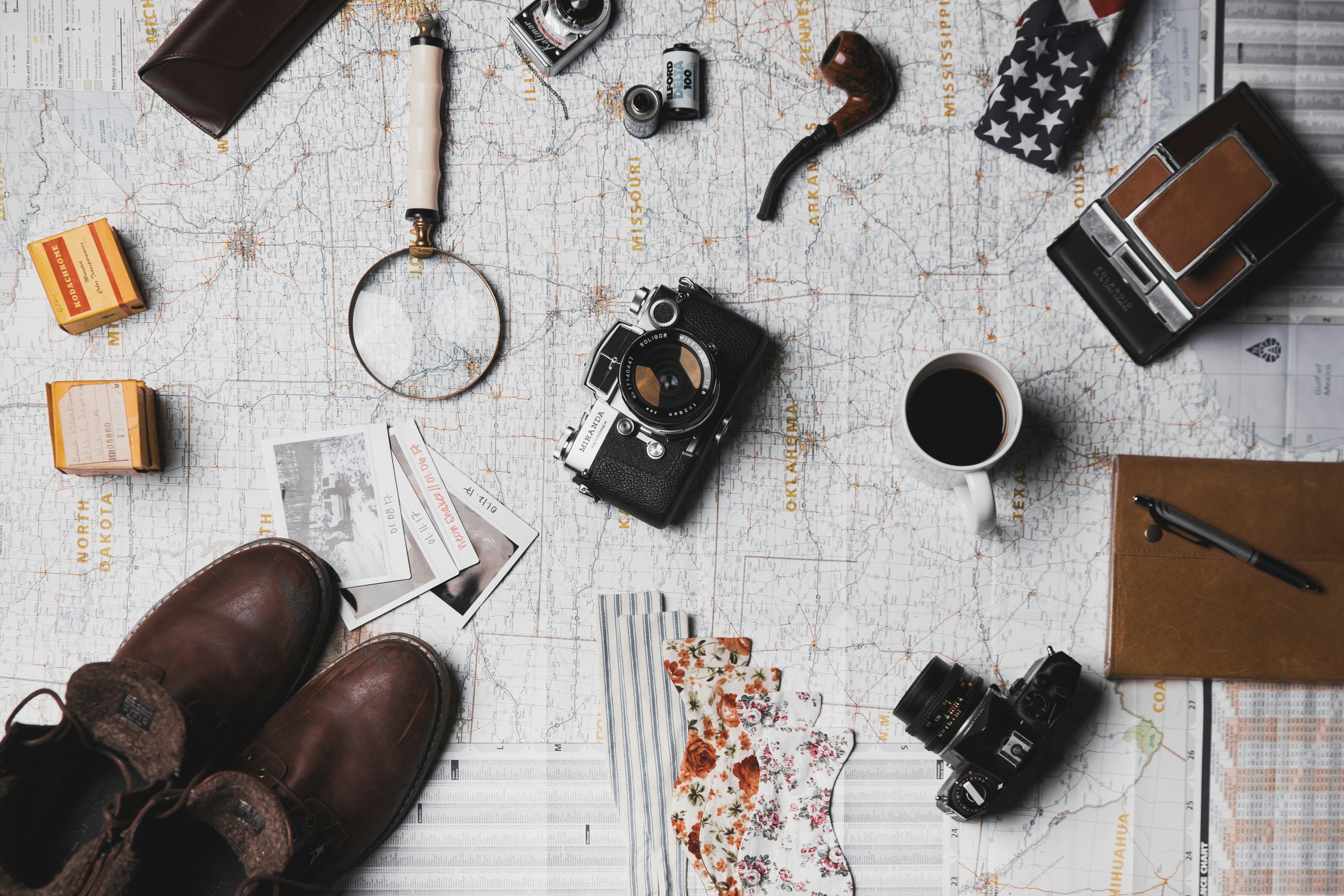 Sustainable Travel | Travel items on top of map | Evolve Tours