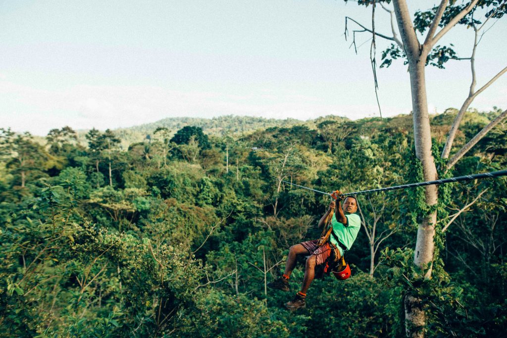 Costa Rica School Trip | Man zip lining over rain forest | Evolve Tours